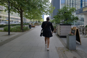 Person wearing a black tiered long-sleeve mini dress going